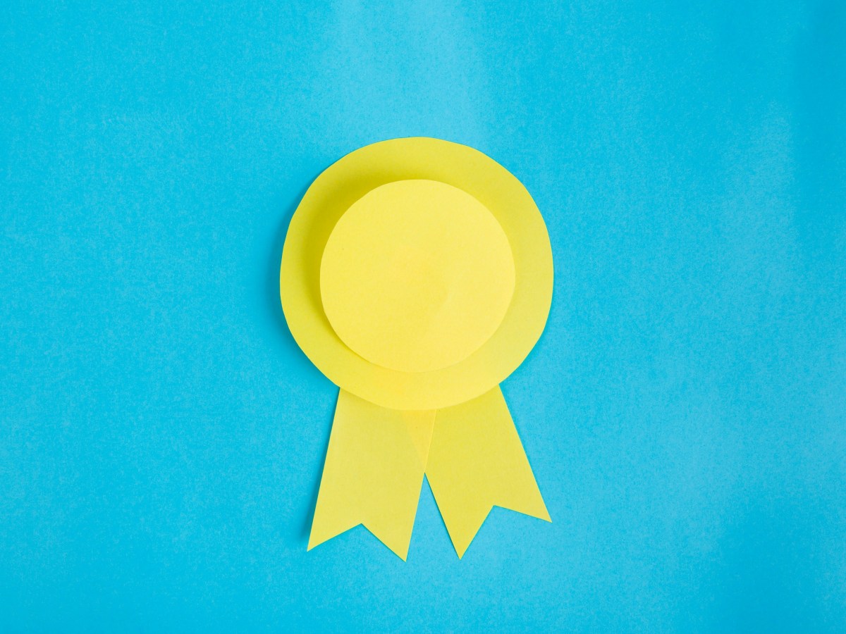 A blue background with a yellow winner's ribbon on it.