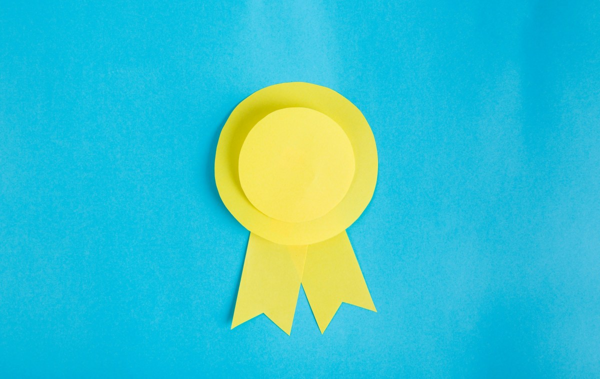 A blue background with a yellow winner's ribbon on it.