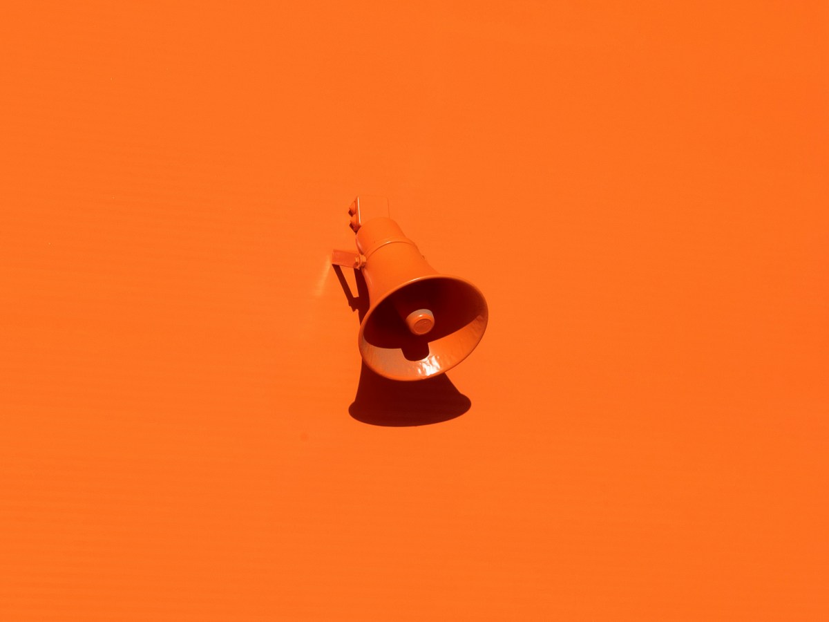 An orange megaphone on an orange background.