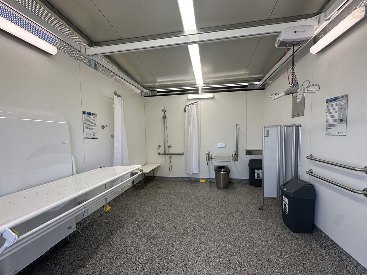 A Changing Places facility, which is an accessible public toilet, with toilet, hoist, bench and bin.