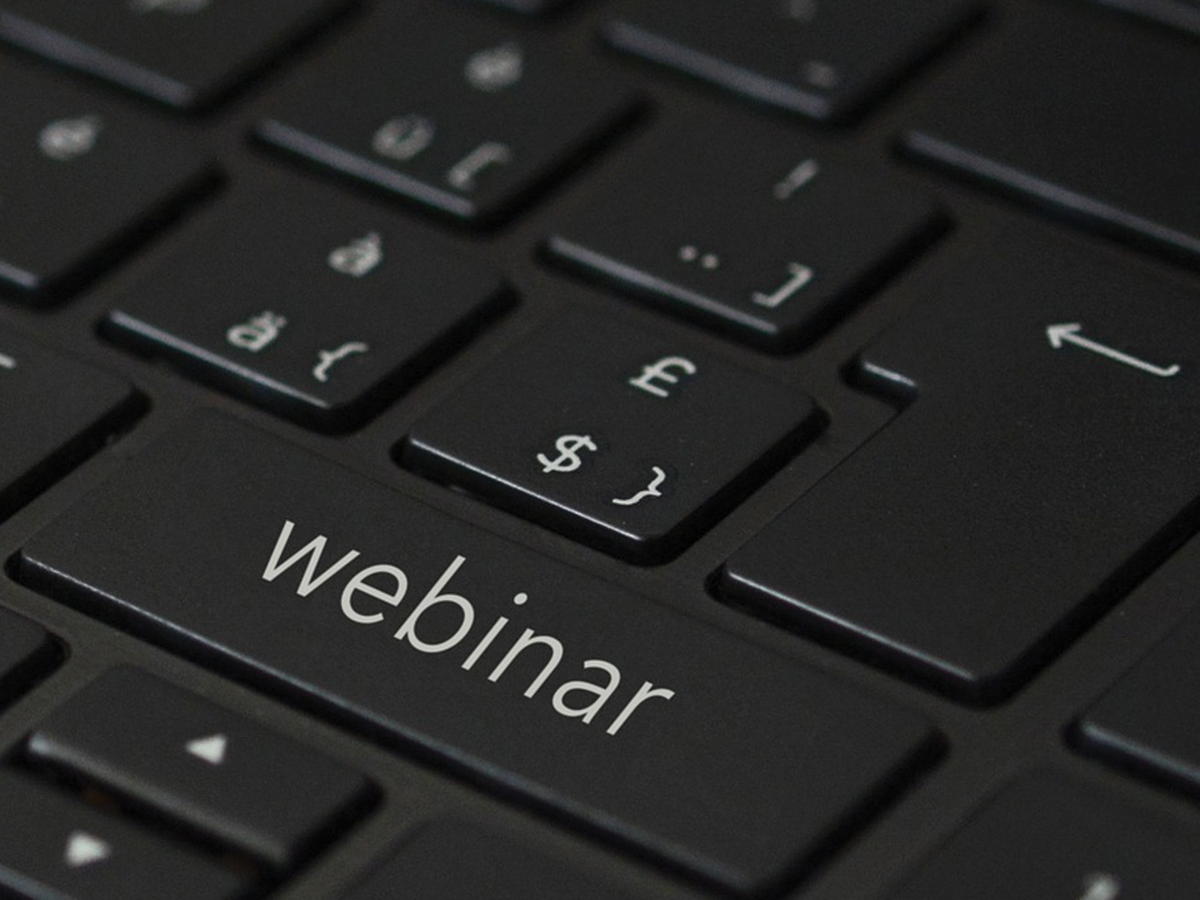 A black keyboard with a key that says Webinar